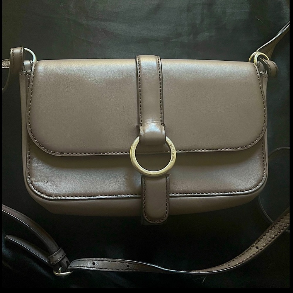 Small Michael Kors lavender purse with shoulder length straps.